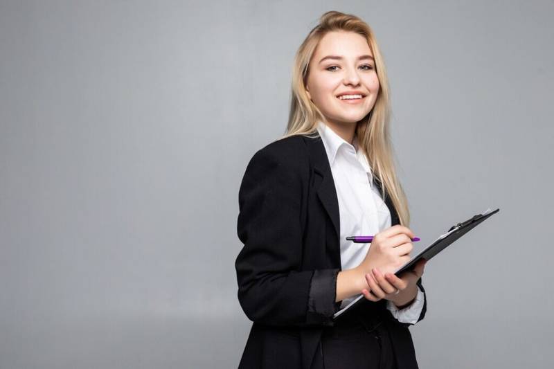 portrait woman holding clip board hands writing paper wearing glasses isolated grey wall 231208 209